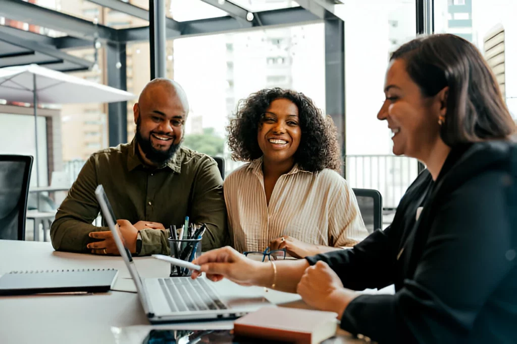 Couple talking to real estate agent in office